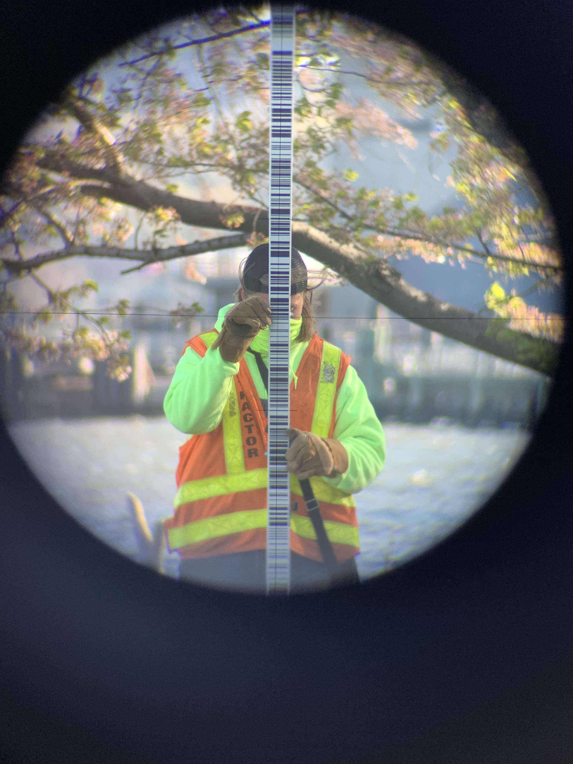surveyor looking through equipment
