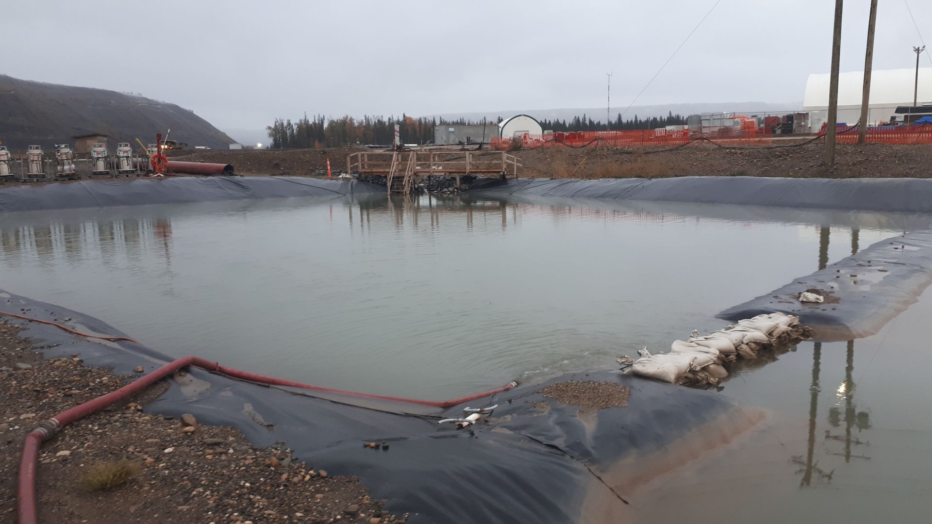 large water area on site with equipment in distance