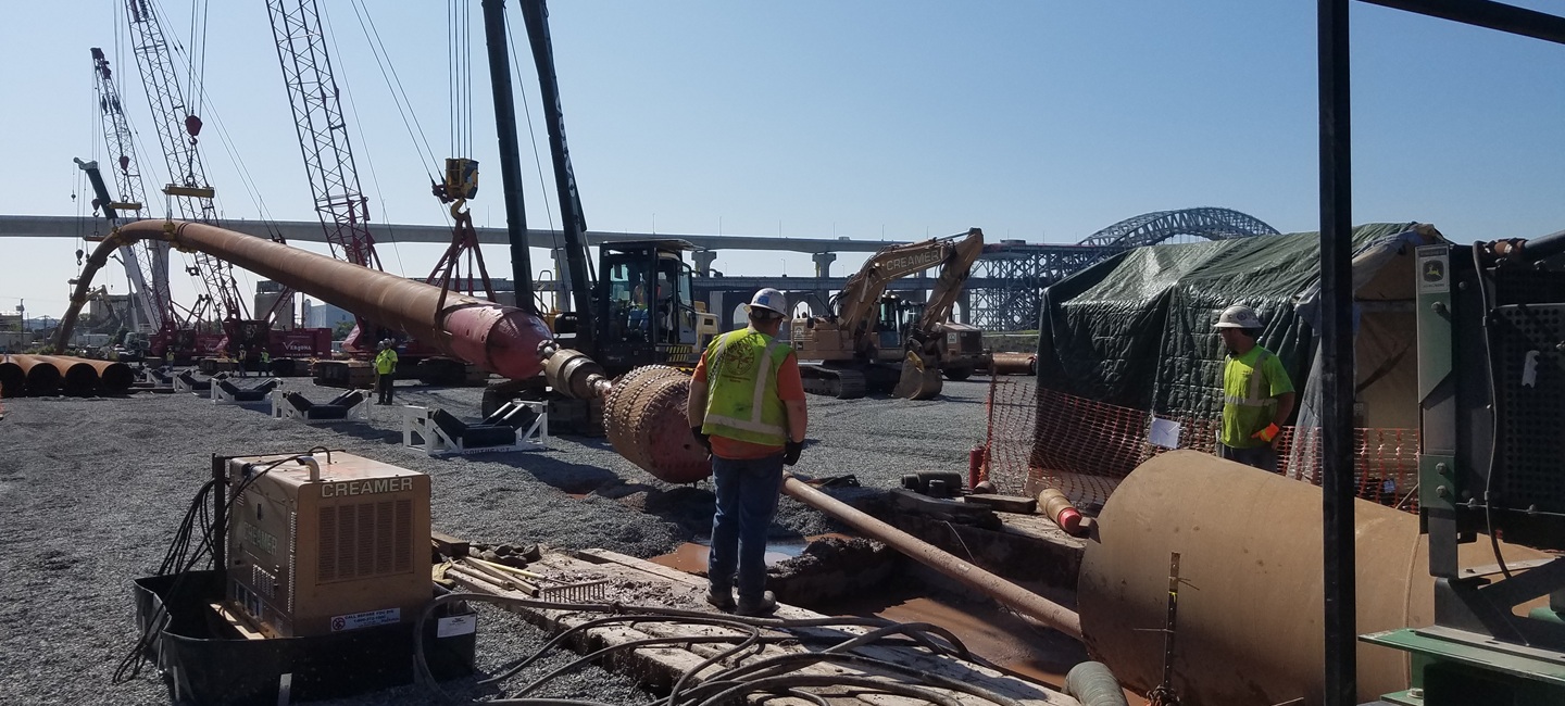 team members on site with construction equipment
