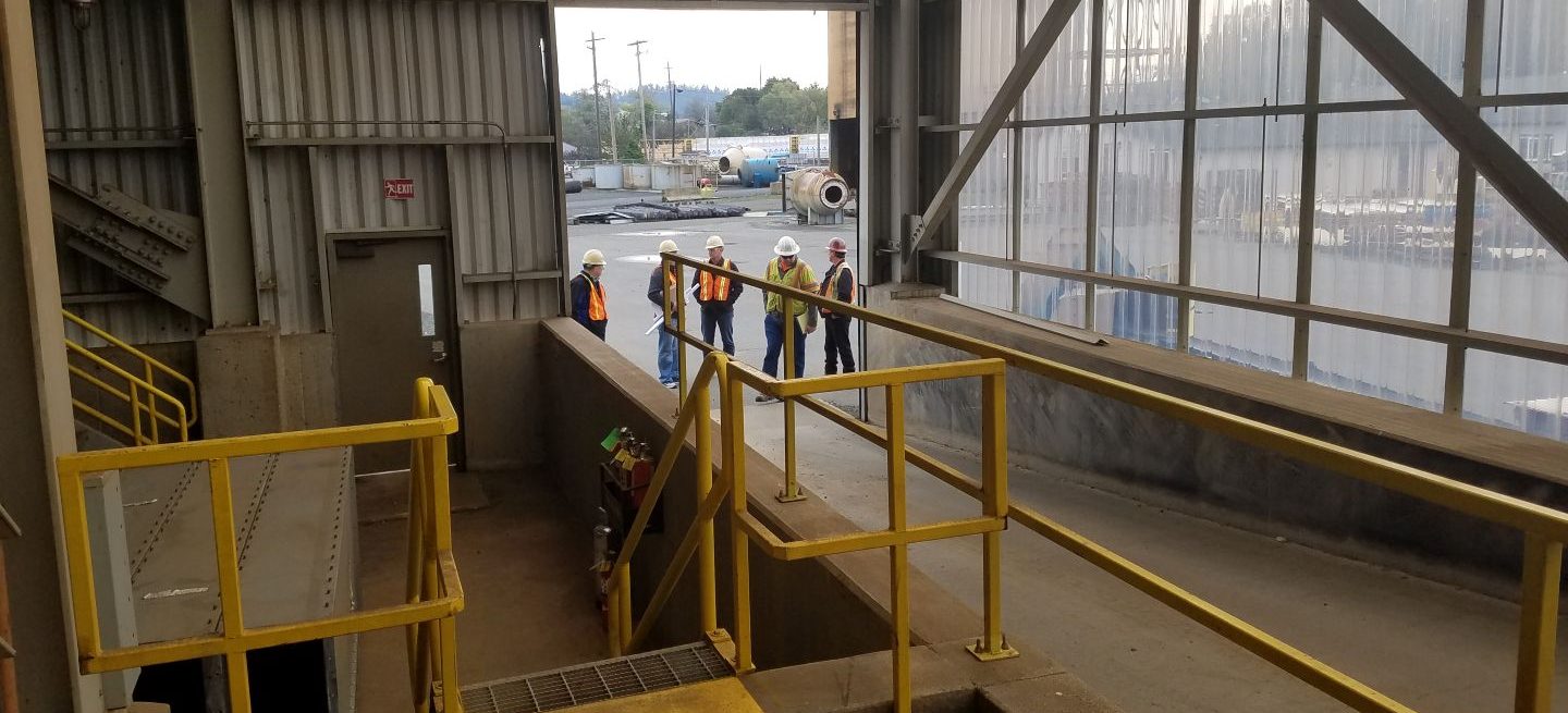 men walking into factory