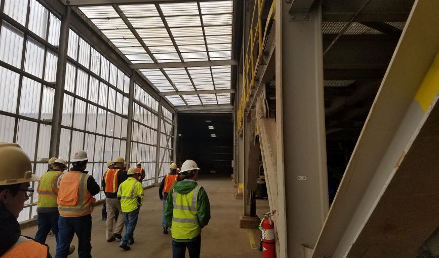 men working on site with glass roof