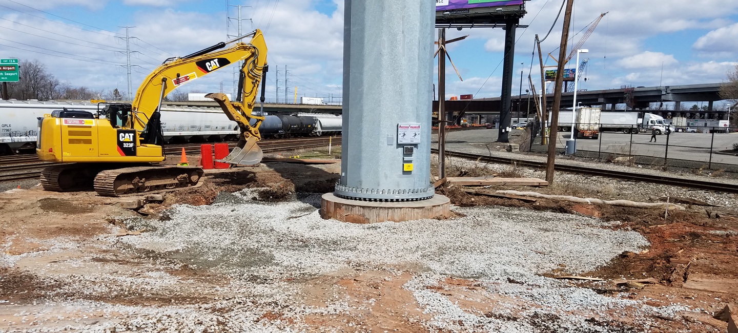 construction equipment with power line foundation on gravel