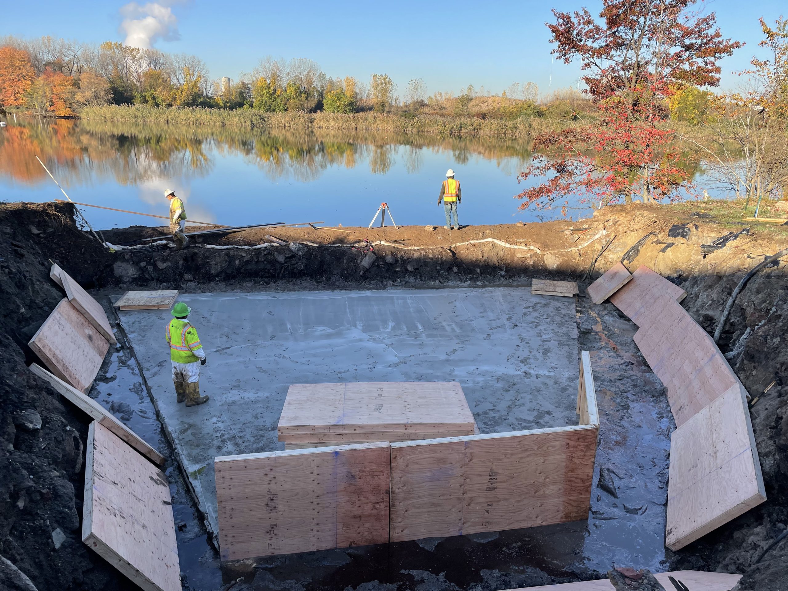 construction along body of water, men working