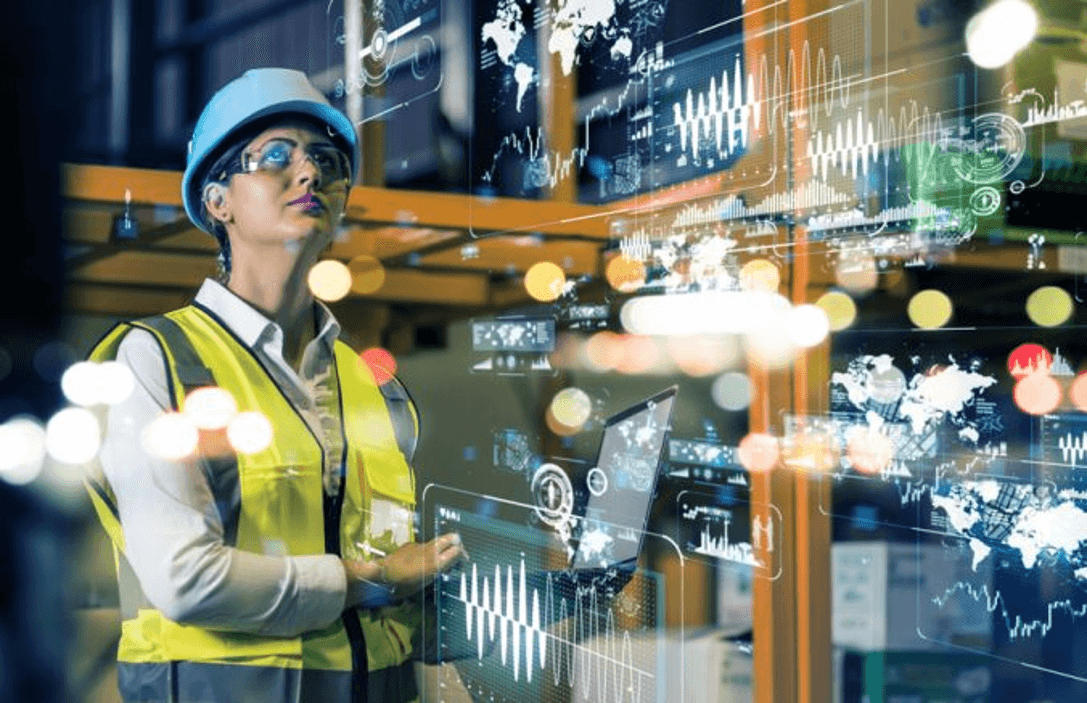 team ember in saftey gear in warehouse with dashboard graphics