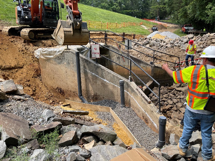 team members on construction site with heavy equipment working