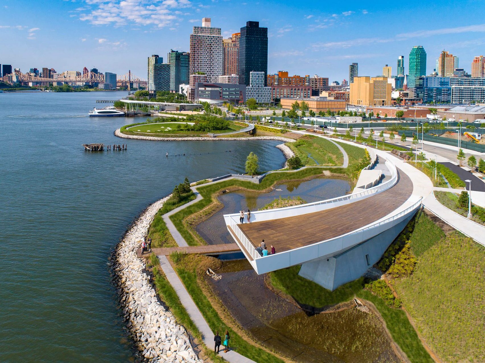 aerial view of park on the water with skyline