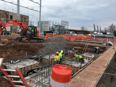 construction workers in a large hole
