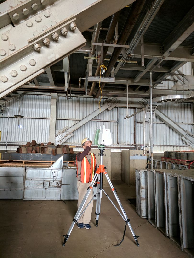 man working with laser scanner in warehouse