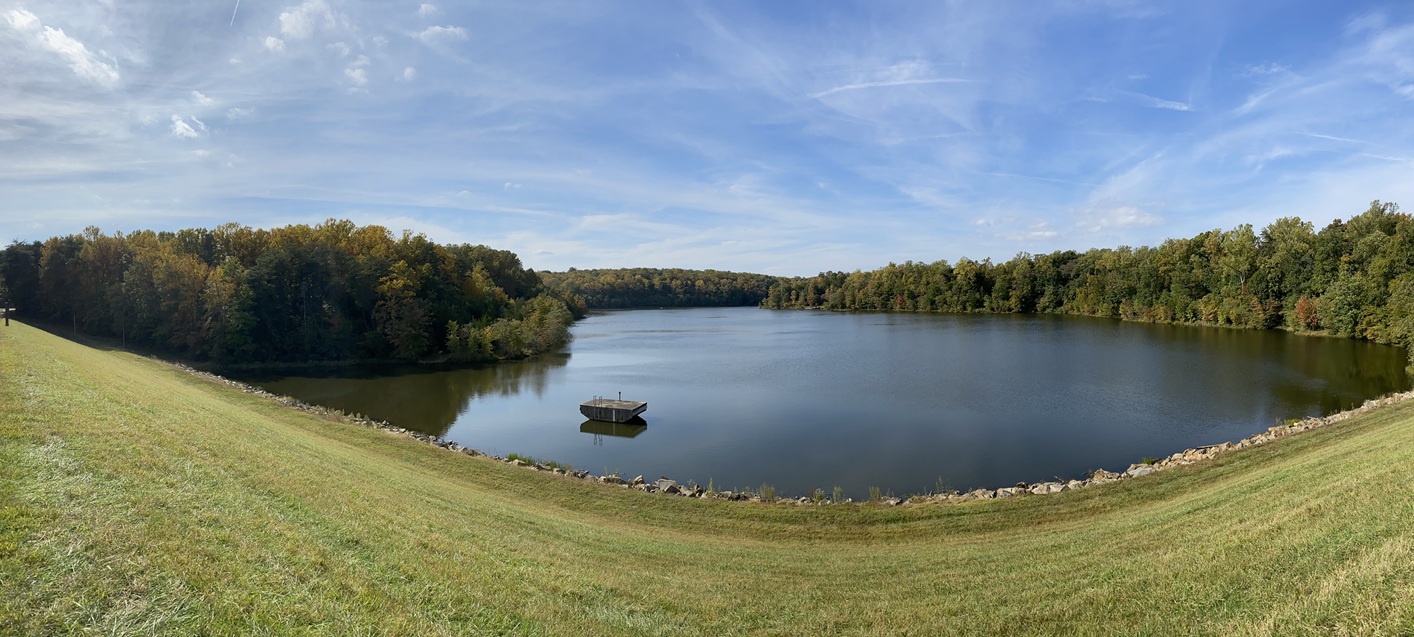 panoramic view of dam with concrete platform in water on the left side
