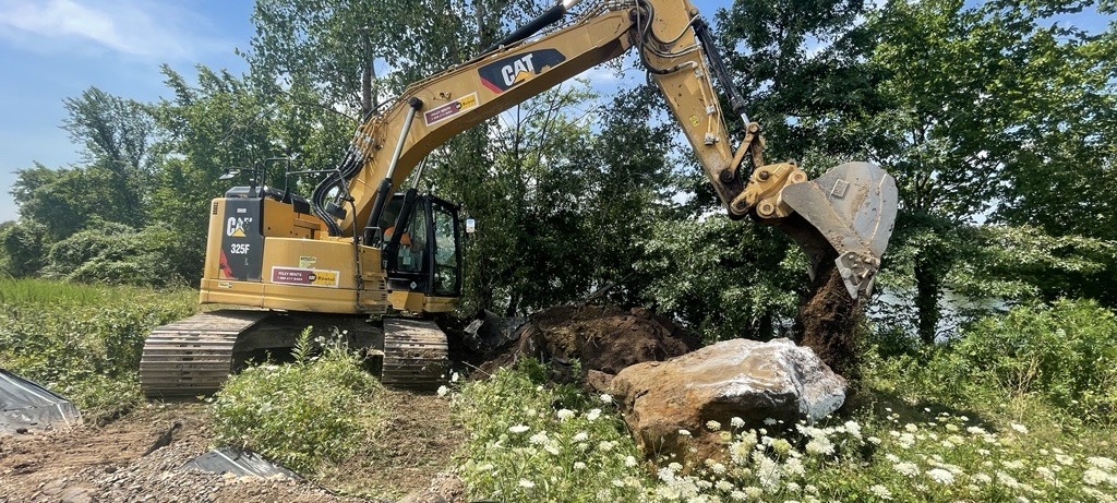backhoe on field about to dig