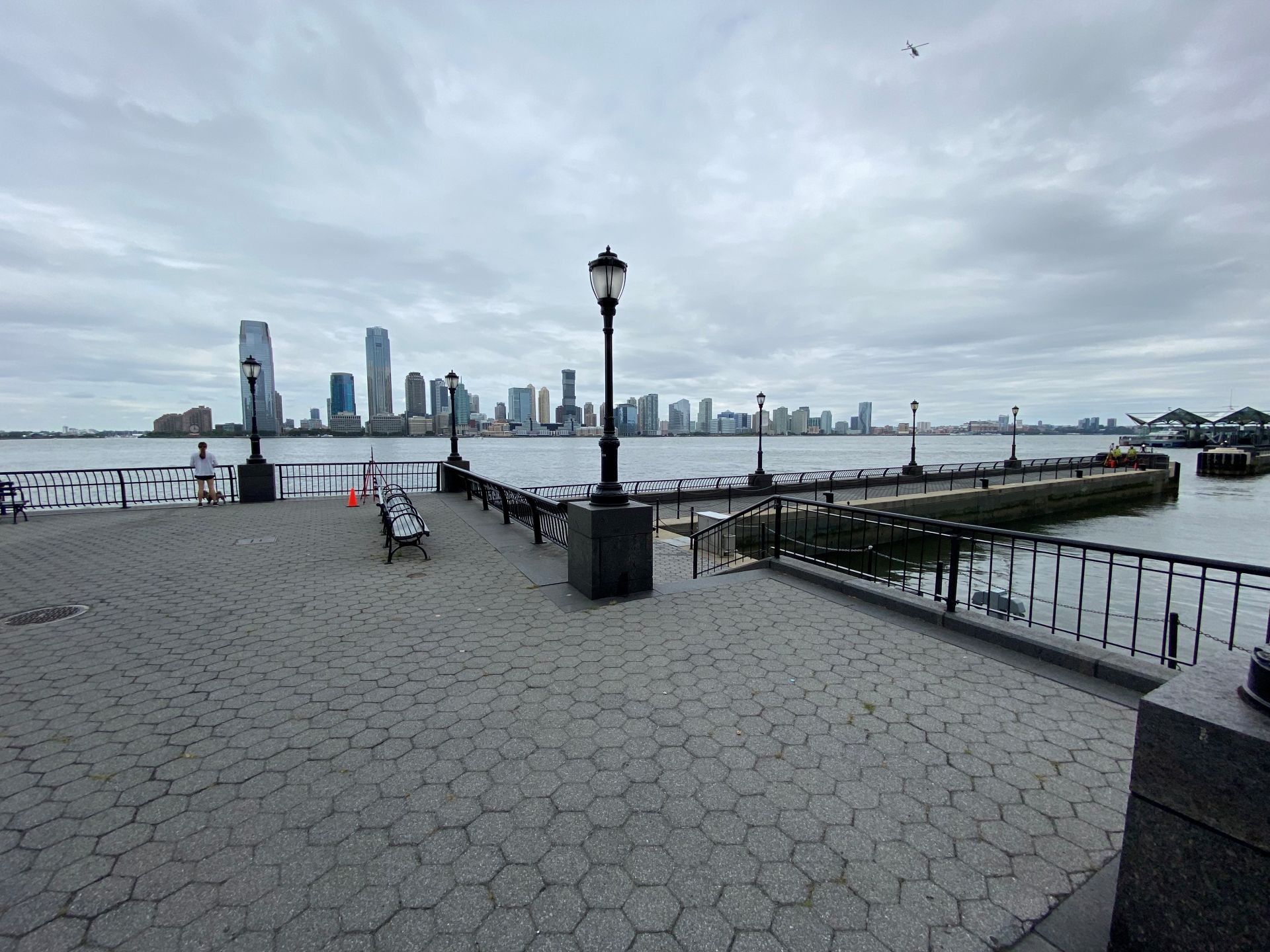 view of north cove with lamp post and benches with skyline across water