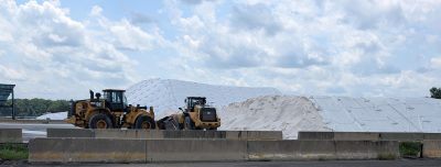 salt piles and backhoes in salt storage facility