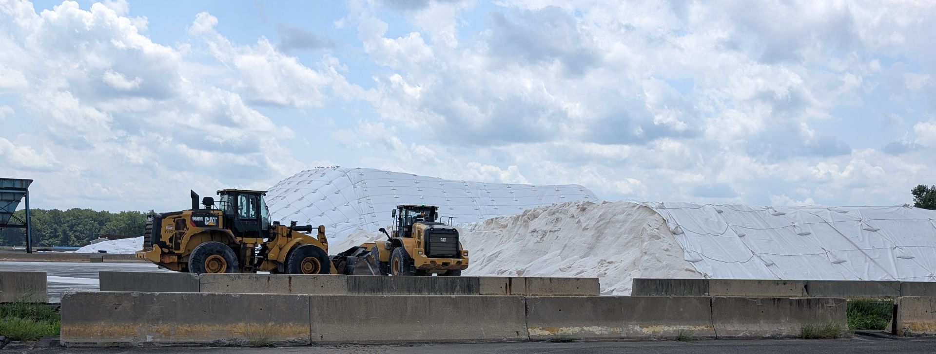 salt piles and backhoes in salt storage facility
