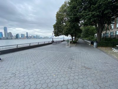 view of park on waterfront with skyline on the left