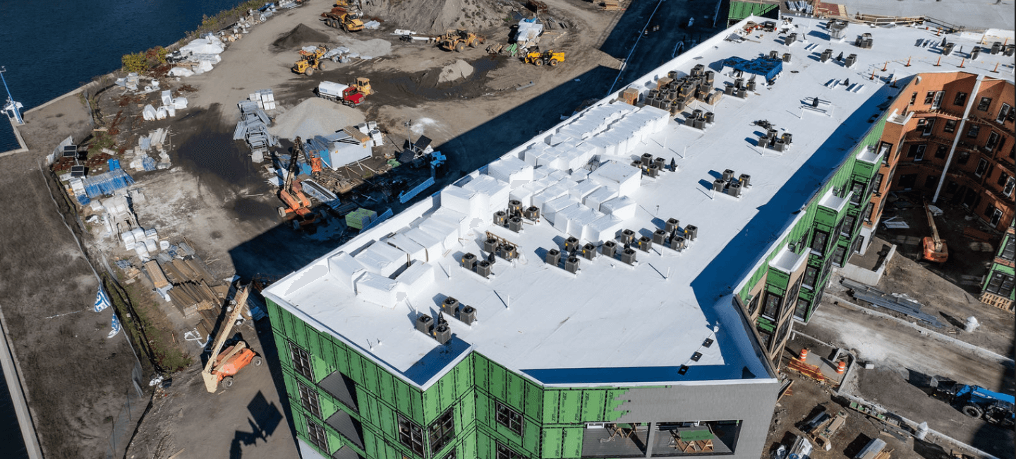 view of building rooftop and surrounding construction site