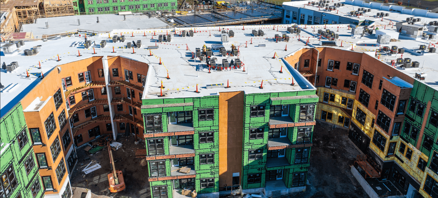 side view and rooftop view of building under construction at steelepoint