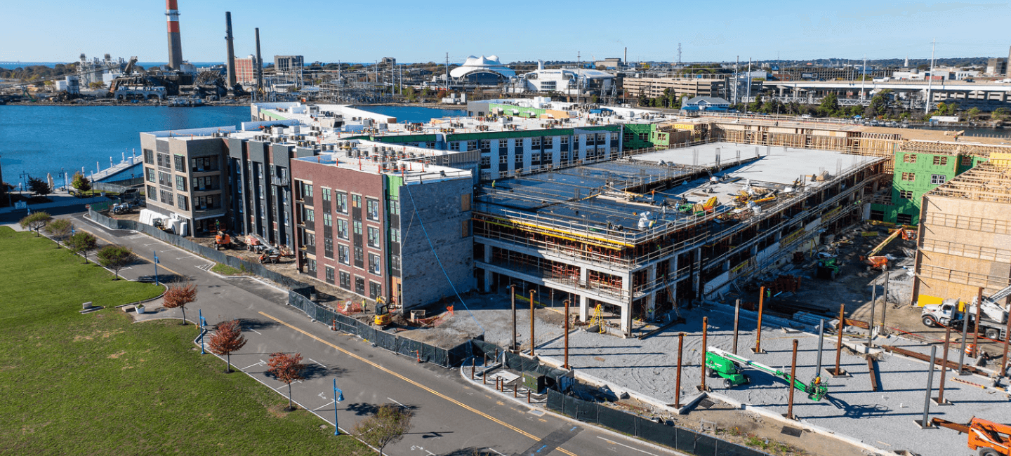 side view of construction area and building complex with river in background